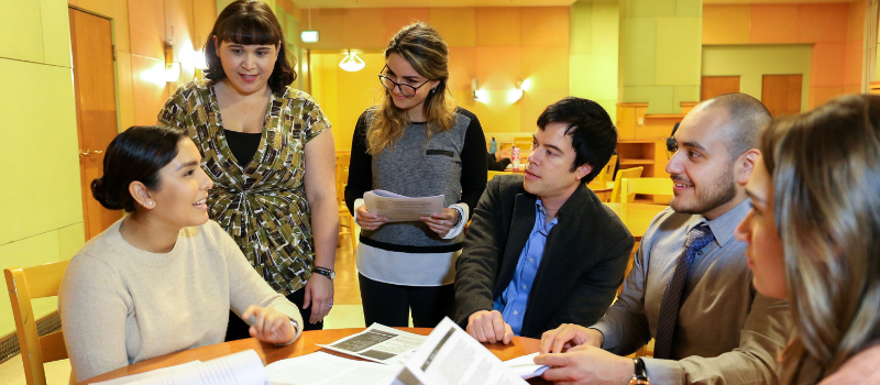 Six students around as table in a discussion