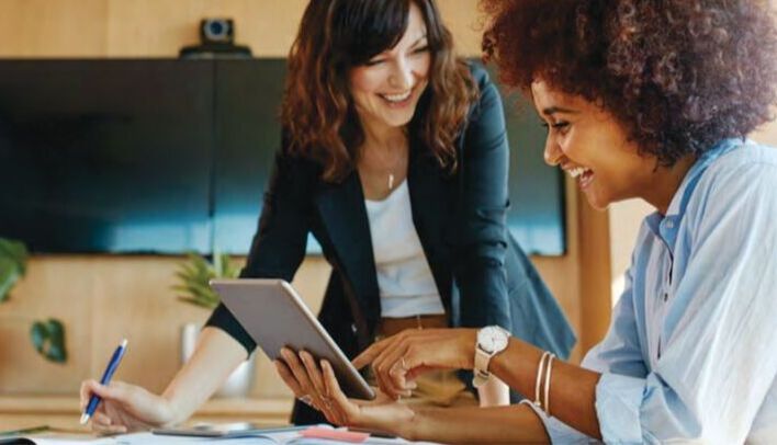 Two women at work smiling