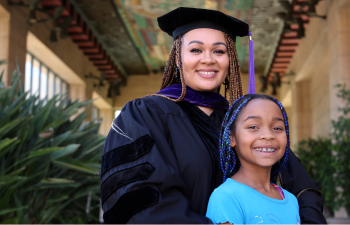 Student in commencement robes with her daughter