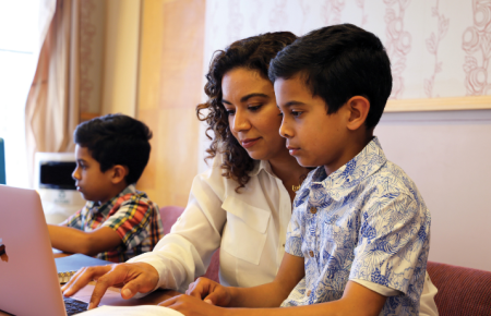 Student with her two children at laptop